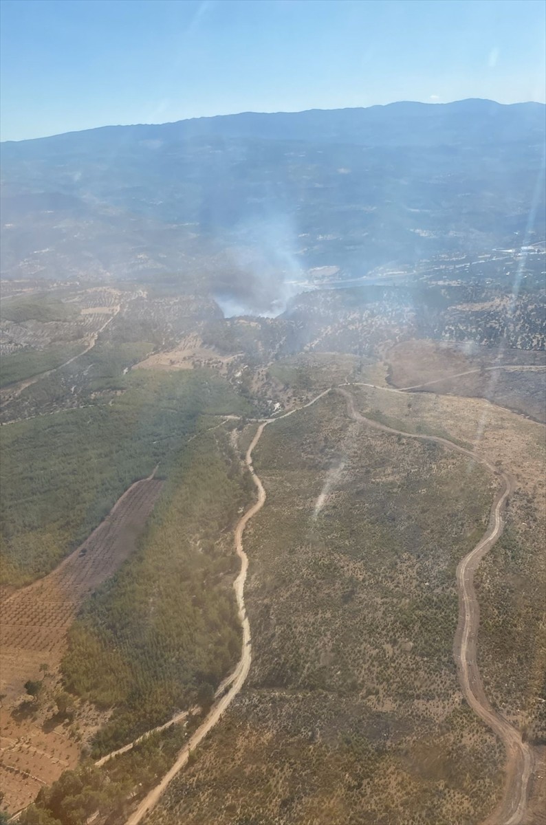 Mersin'in Silifke ilçesinde ormanlık alanda çıkan yangının kontrol altına alınması için havadan ve...